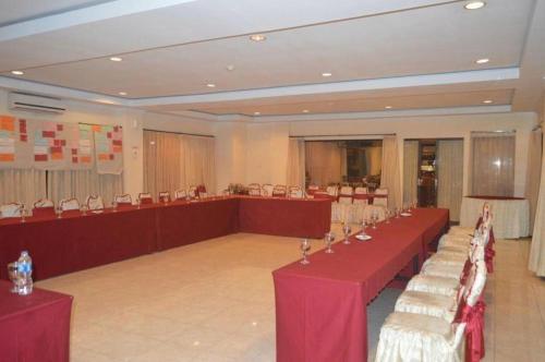 a large room with tables and chairs in a room at Jimbarwana Hotel in Negara