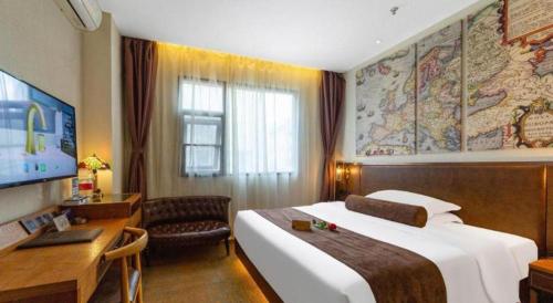 a hotel room with a large bed and a desk at James Joyce Coffetel Xi'an Lingtong The Terracotta Army Huaqingchi University Town Metro Station in Xi'an