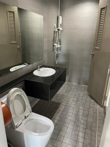 a bathroom with a toilet and a sink at Bake Room Hostel in Chiang Mai