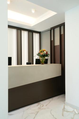 a lobby with a vase of flowers on a counter at Melia Venezia Lido in Venice-Lido