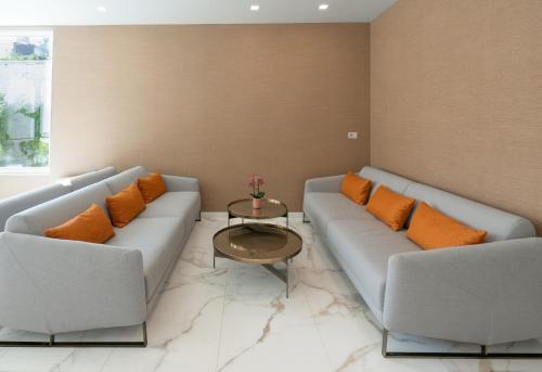 a living room with two couches and a table at Melia Venezia Lido in Venice-Lido