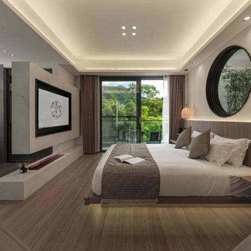 a bedroom with a large bed and a large window at Anji Xishan Linyu Chinese-style Spring · Stream Tracing · Vacation Boutique Inn in Anji