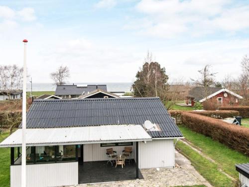 a white house with a black roof at 6 person holiday home in Nordborg in Nordborg