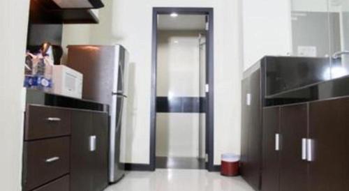 a kitchen with a stainless steel refrigerator and cabinets at The BCC Hotel & Residence in Nagoya