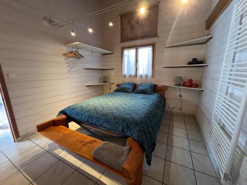 a bedroom with a bed in a small room at Chalet des Anges in Youx