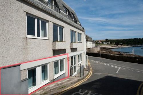 
a large building with a view of the water at Seaspray in Saint Mawes

