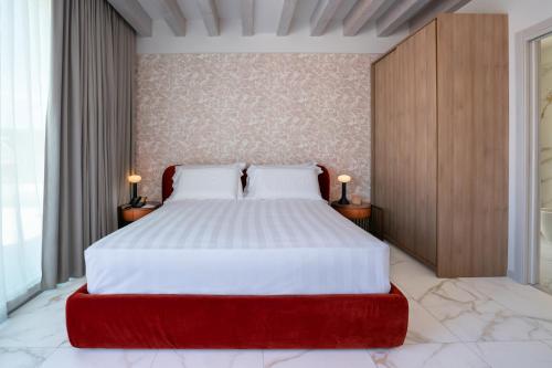 a bedroom with a large bed with a red foot board at Melia Venezia Lido in Venice-Lido