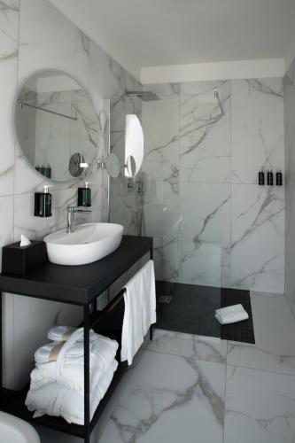 a bathroom with a sink and a mirror at Melia Venezia Lido in Venice-Lido