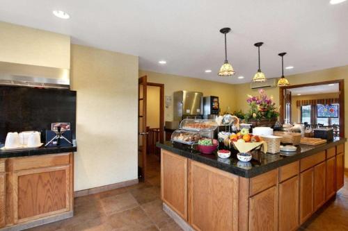 a kitchen with a counter with food on it at Quality Inn & Suites Detroit Lakes in Detroit Lakes