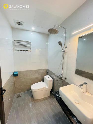 a bathroom with a toilet and a sink at Salahomes Apartment by Dapano in Hanoi
