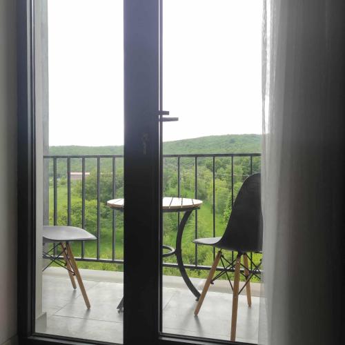 a view of a balcony with a table and chairs at Kechi Apart, Hotel Nice View No 139, 6th floor in Tsaghkadzor
