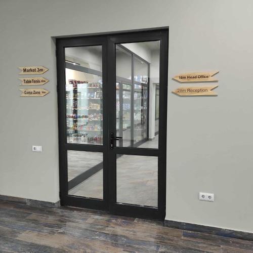 a black door in a store with signs on it at Kechi Apart, Hotel Nice View No 139, 6th floor in Tsaghkadzor
