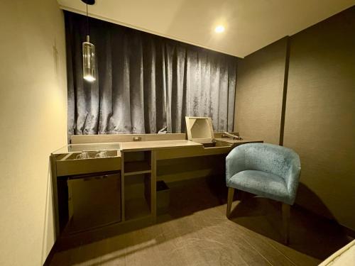 a room with a desk with a chair and a laptop at HOTEL AMANEK Osaka Namba in Osaka