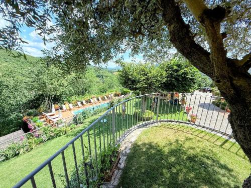 a garden with a fence and a swimming pool at Torretta sleeps 5 with pool and exclusive gardens plus private verandah in Strettura