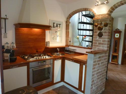 a kitchen with a sink and a stove top oven at Ciabòt Taricchi in Dogliani