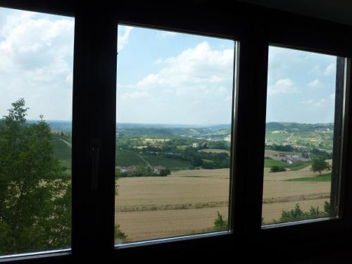 a view of a field from a window at Ciabòt Taricchi in Dogliani