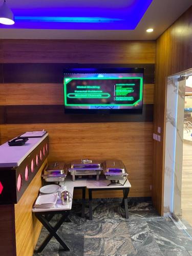 a dining room with a table and a tv at Presken Kuramo Waters in Lagos