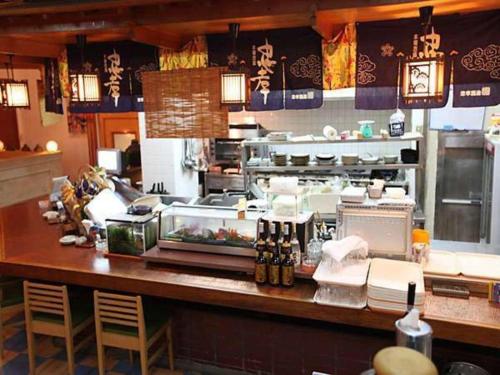 a kitchen with a counter in a restaurant at Okinawa Sunplaza Hotel in Naha