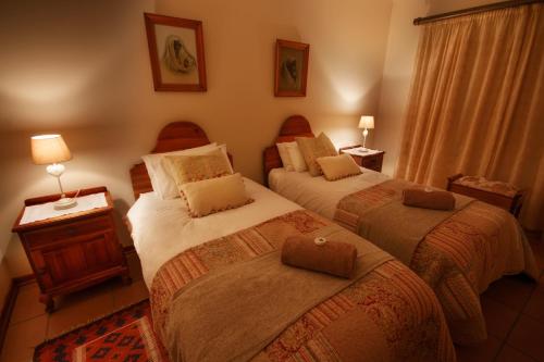 a hotel room with two beds in a room at Clarens Cottage 2 in Clarens