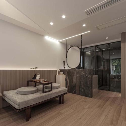 a bathroom with a bench and a shower and a mirror at Anji Xishan Linyu Chinese-style Spring · Stream Tracing · Vacation Boutique Inn in Anji