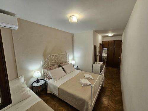 a small bedroom with a bed and a couch at Room Gorana with swimming pool in Jelsa