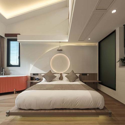 a bedroom with a large bed with a large orb on the wall at Anji Xishan Linyu Chinese-style Spring · Stream Tracing · Vacation Boutique Inn in Anji