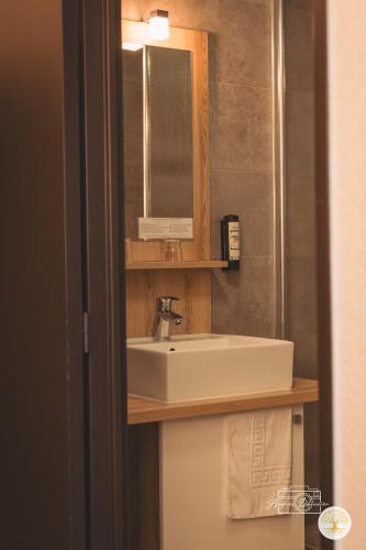 a bathroom with a sink and a mirror at Hotel Chantereyne in Cherbourg en Cotentin