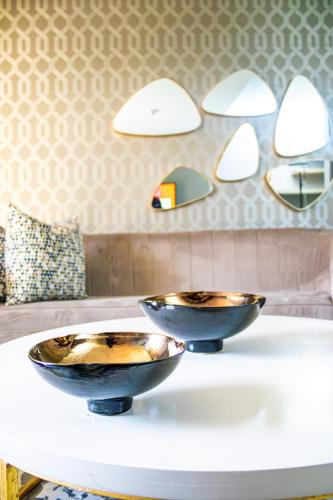 two bowls on a table with mirrors on the wall at Happy Valley Hotel and Casino in Ezulwini