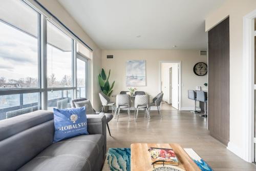 a living room with a couch and a table at Stylish 2 BR & Den 2BA with Free Parking in Toronto