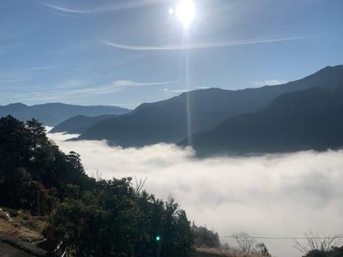 a view of a foggy valley with mountains in the background at Minka -STAY Traditional Japanese houses in Miyoshi