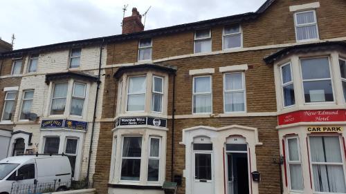 a brick building with a van parked in front of it at Wishing Well Guest House in Blackpool