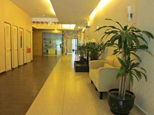 a living room with a couch and a plant at Uptown Imperial Kajang in Kuala Lumpur