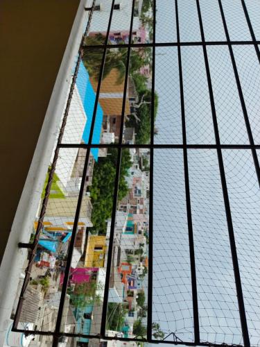 a stained glass window with a view of a city at Auro Maison in Puducherry
