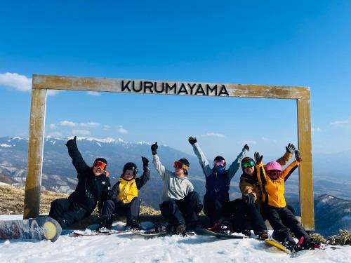 a group of people sitting on top of a mountain at Guesthouse HOALOHA 4 SEASONS in Chino