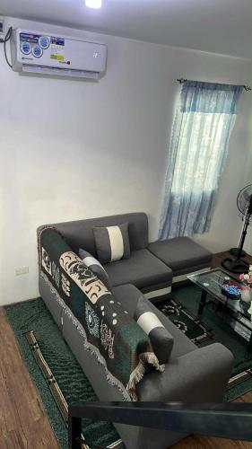 a living room with a couch and a tv at Lubrin Townhouse in San Pablo
