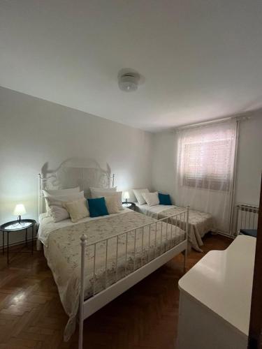 a bedroom with two beds and a window at Apartment with swimming pool in Jelsa