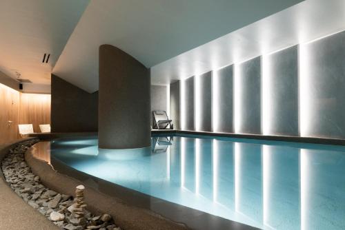 a swimming pool in a building with a pool at Electra Palace Thessaloniki in Thessaloniki