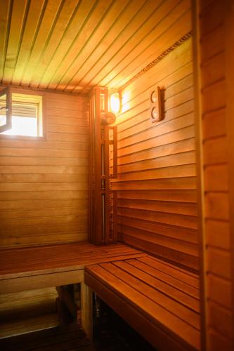 a wooden sauna with a bench in a room at Marupes pirts in Mārupe