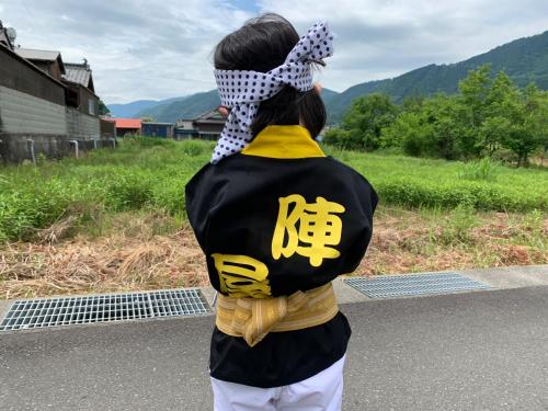 a woman with a scarf on her head standing on a road at Minka -STAY Traditional Japanese houses in Miyoshi