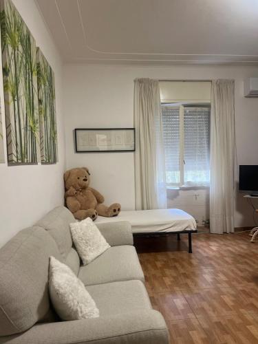 a teddy bear sitting on a couch in a living room at Ancora Sul Naviglio in Rozzano