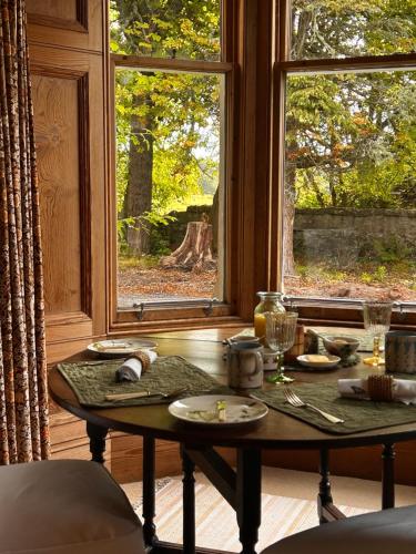 a table in a room with a window at Clashmore House in Dornoch
