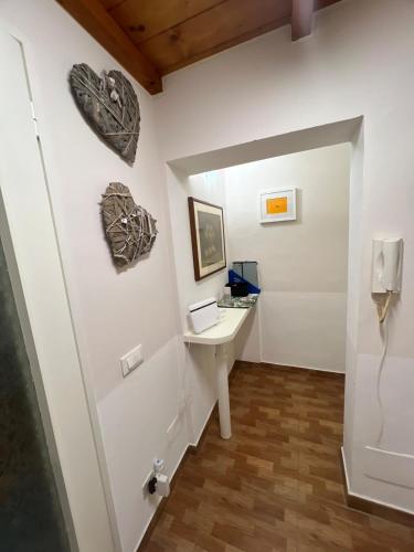 a white room with a sink and a mirror at Ancora Sul Naviglio in Rozzano