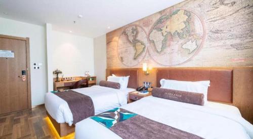 a hotel room with two beds and a map on the wall at James Joyce Coffetel Shenyang North Railway Station Qishan Road Metro Station in Shenyang