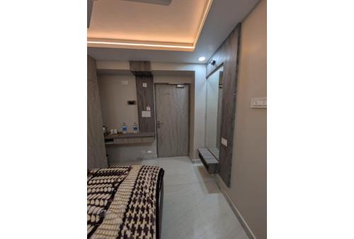a hotel room with a bed and a bathroom at Haritwal Guest House in Varanasi