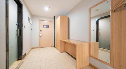 a hallway with a dressing room with a mirror at 7 Days Premium Xi'an Dayan Tower Xiaozhai Metro Station in Xi'an