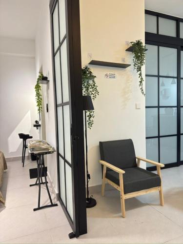 a living room with a chair and a table at Langit dan Lantai #168ParkSelayangMall #HospitalSelayang #UitmSelayang in Kampong Jawa Tengah