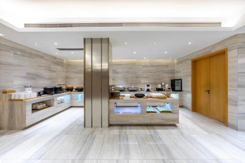 a large kitchen with a large island in a room at Ji Hotel Shanghai Changshou Road - Near Metro Line 13&14,Free Luggage Storage,English Service in Shanghai