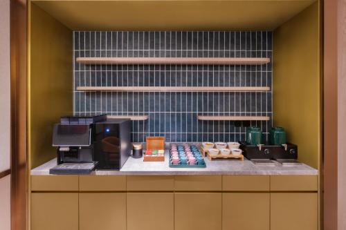 a kitchen with a counter with a coffee maker at Beijing Guanganmen Niujie Manxin Hotel in Beijing