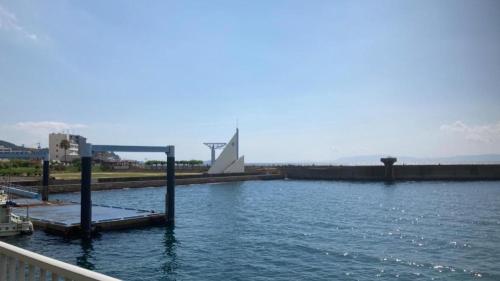 a large body of water with a building in the background at Hamakan Hotel in Unzen