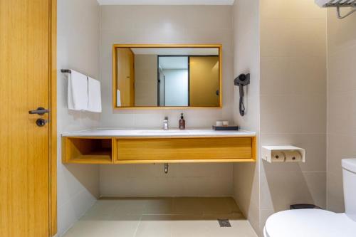 a bathroom with a sink and a mirror at Ji Hotel Shanghai Changshou Road - Near Metro Line 13&14,Free Luggage Storage,English Service in Shanghai